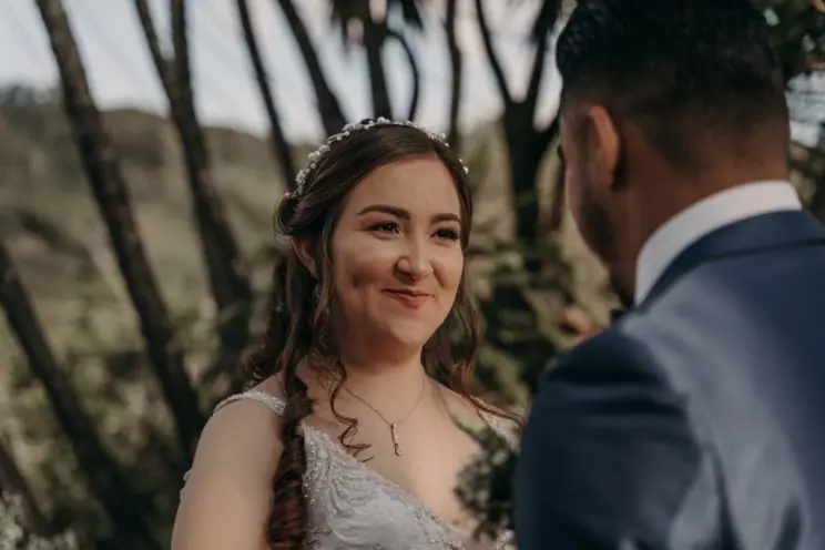 Bride smiling at the groom during an outdoor ceremony