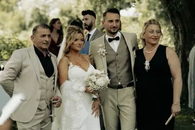 Newlyweds posing with family at an outdoor wedding