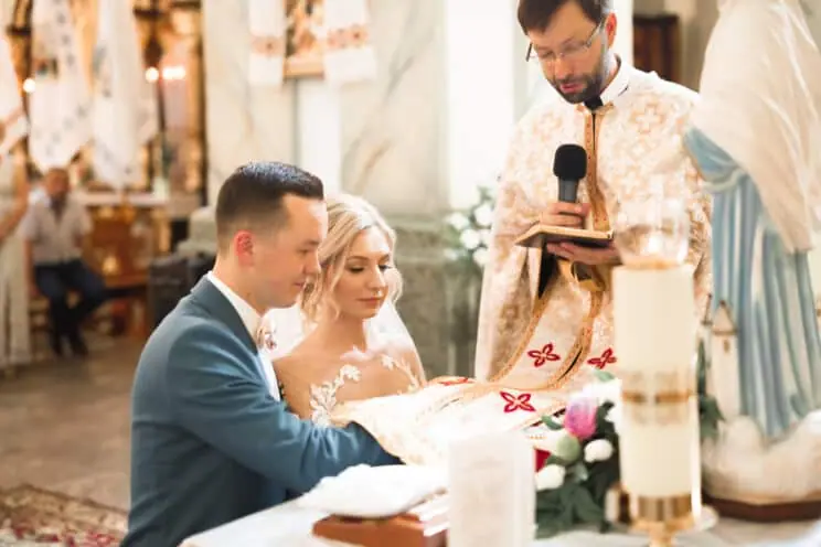 Couple signing the register during an Orthodox wedding ceremony